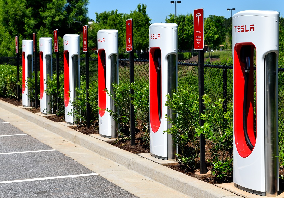 image of Tesla electric car charging stations in public parking lot